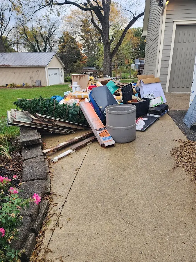 Dumpster being loaded with debris for 12 Yard Dumpster Rental in Bridgeview